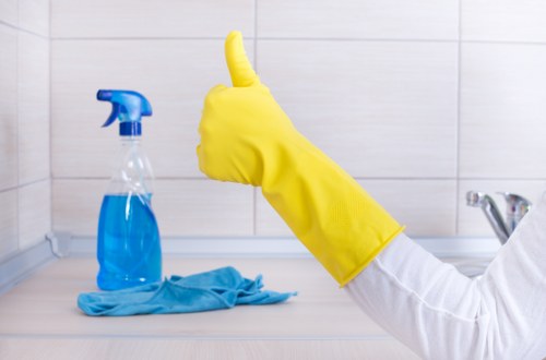 Cleaner maintaining a kitchen and break area in an SW5 workplace